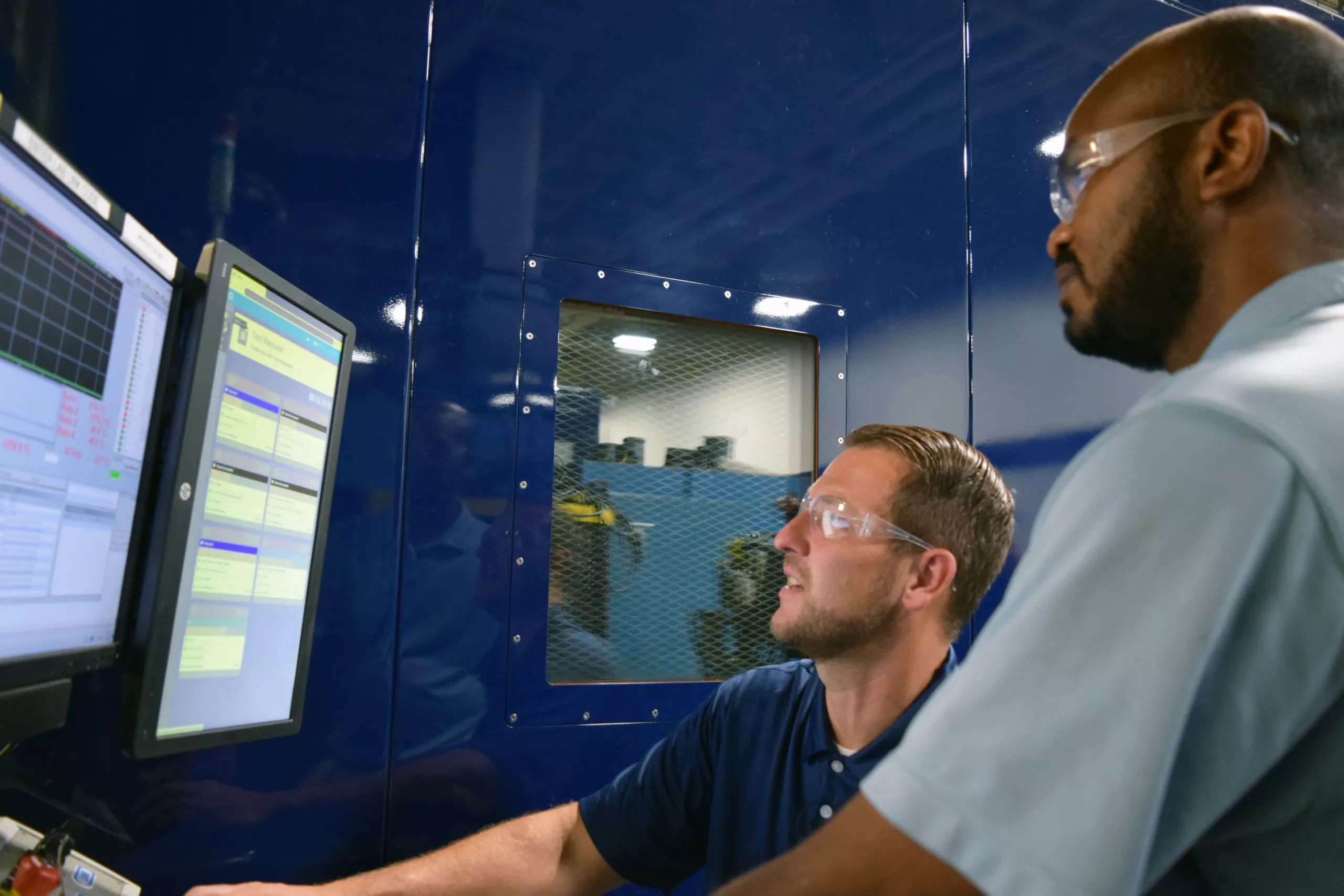 Two members of the Link Engineering team analyze results on a software application.